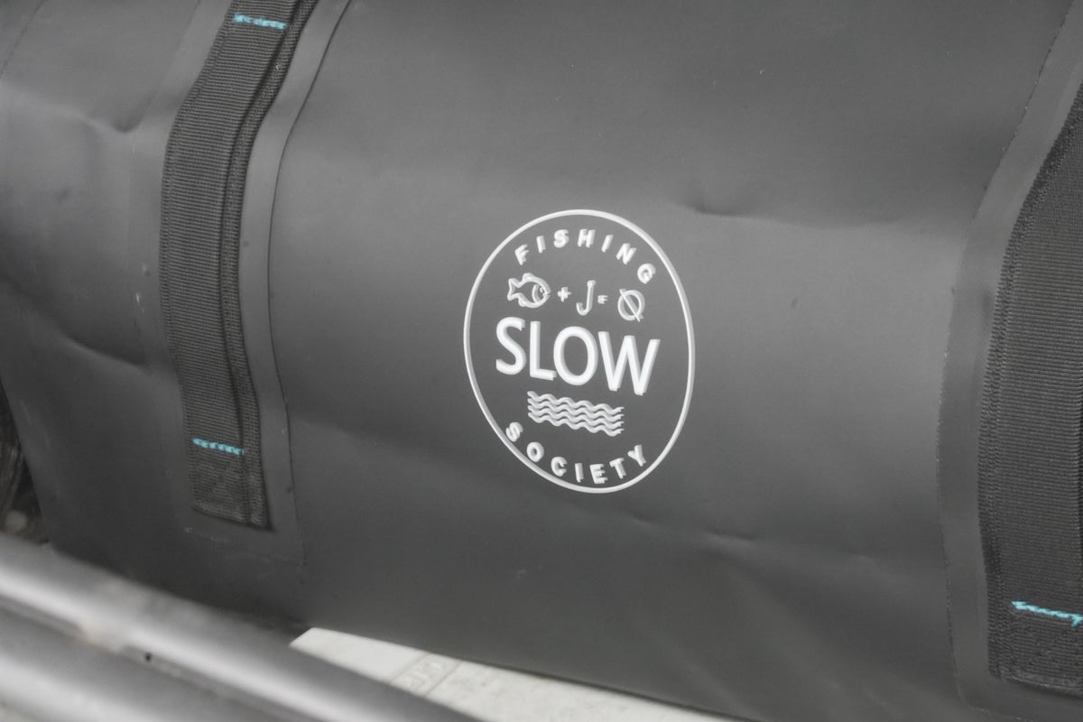 Slow Fishing Society logo on the black duffle