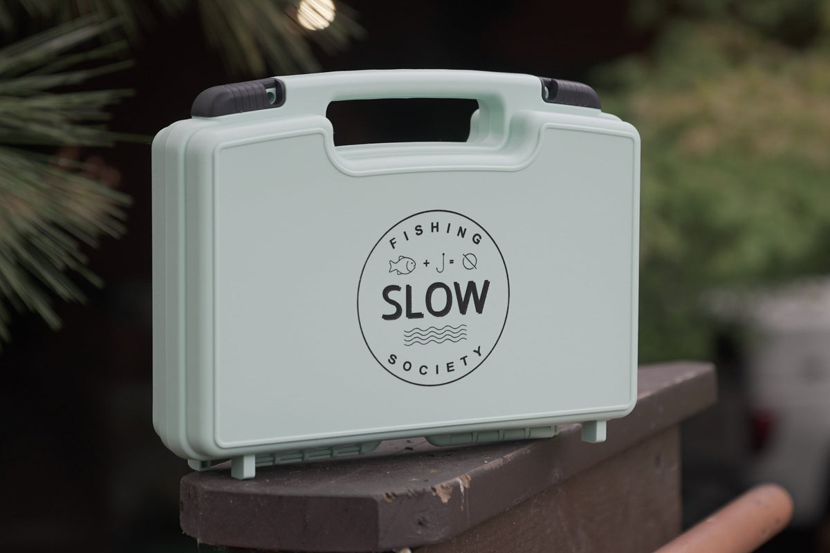 Closed sage green SLOW Fishing Society fly box