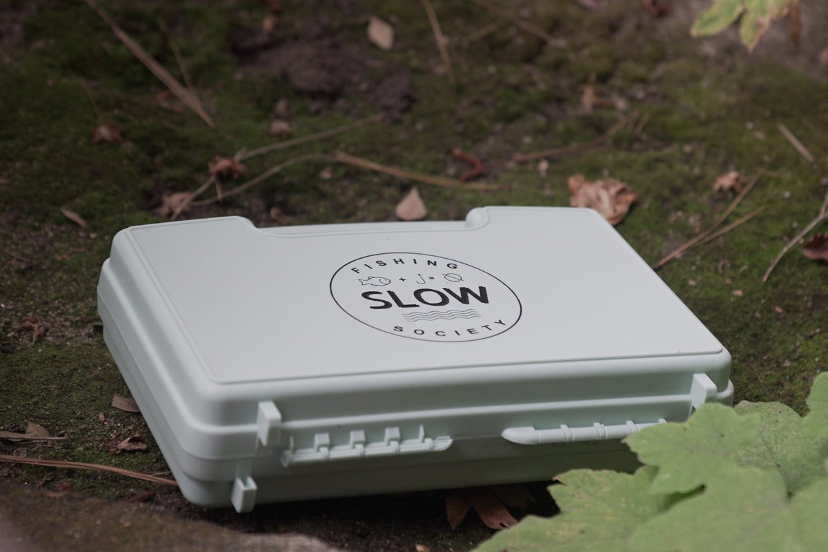 Slow Fishing Society fly box on moss