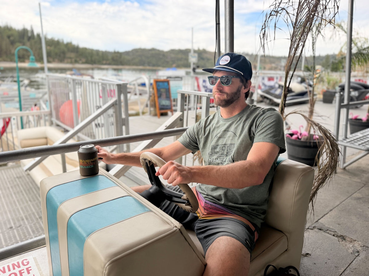 Dark blue Slow Fishing Society hat on the dock