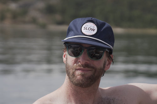 Dark blue Slow Fishing Society hat close-up